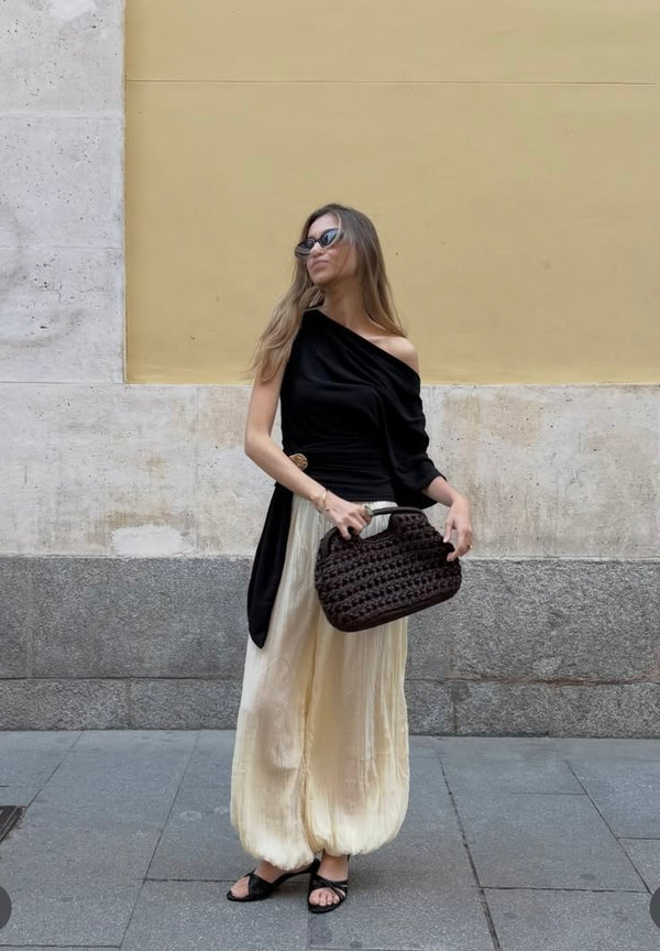 woman carrying dark brown crochet handbag with evening outfit