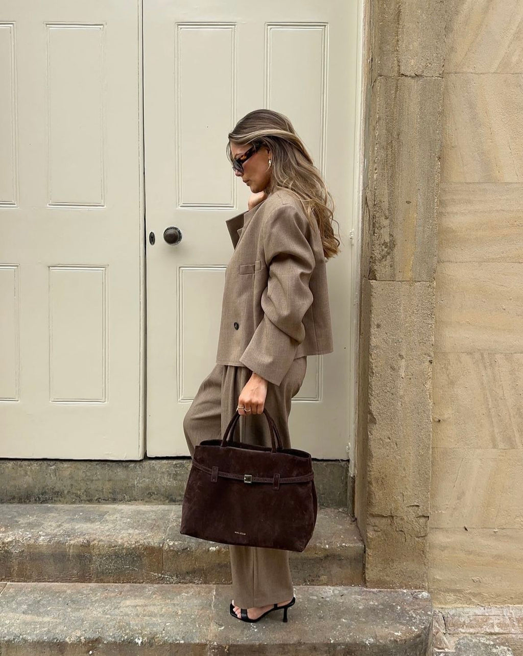 Sienna deep brown suede top handle bag styled with an oversized blazer and trousers
