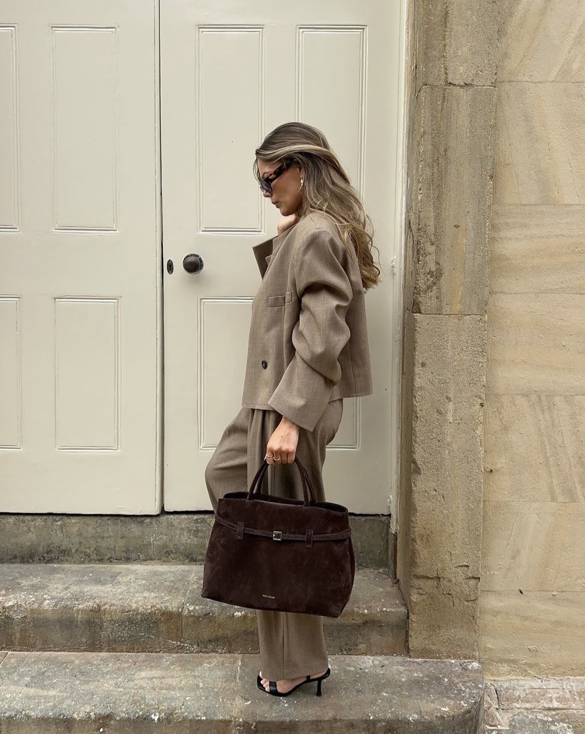 Sienna deep brown suede top handle bag styled with an oversized blazer and trousers