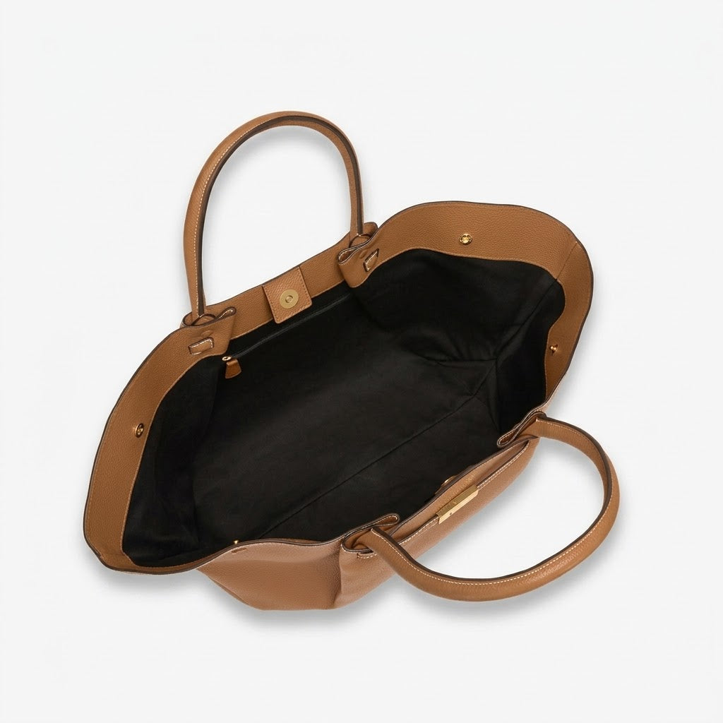 Close-up of brown Manhattan Tote with gold-tone clasp and stitching