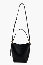 black bucket bag with a long crossbody strap and short handle