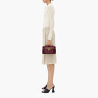women carrying woven mini bag crossbody street style close up