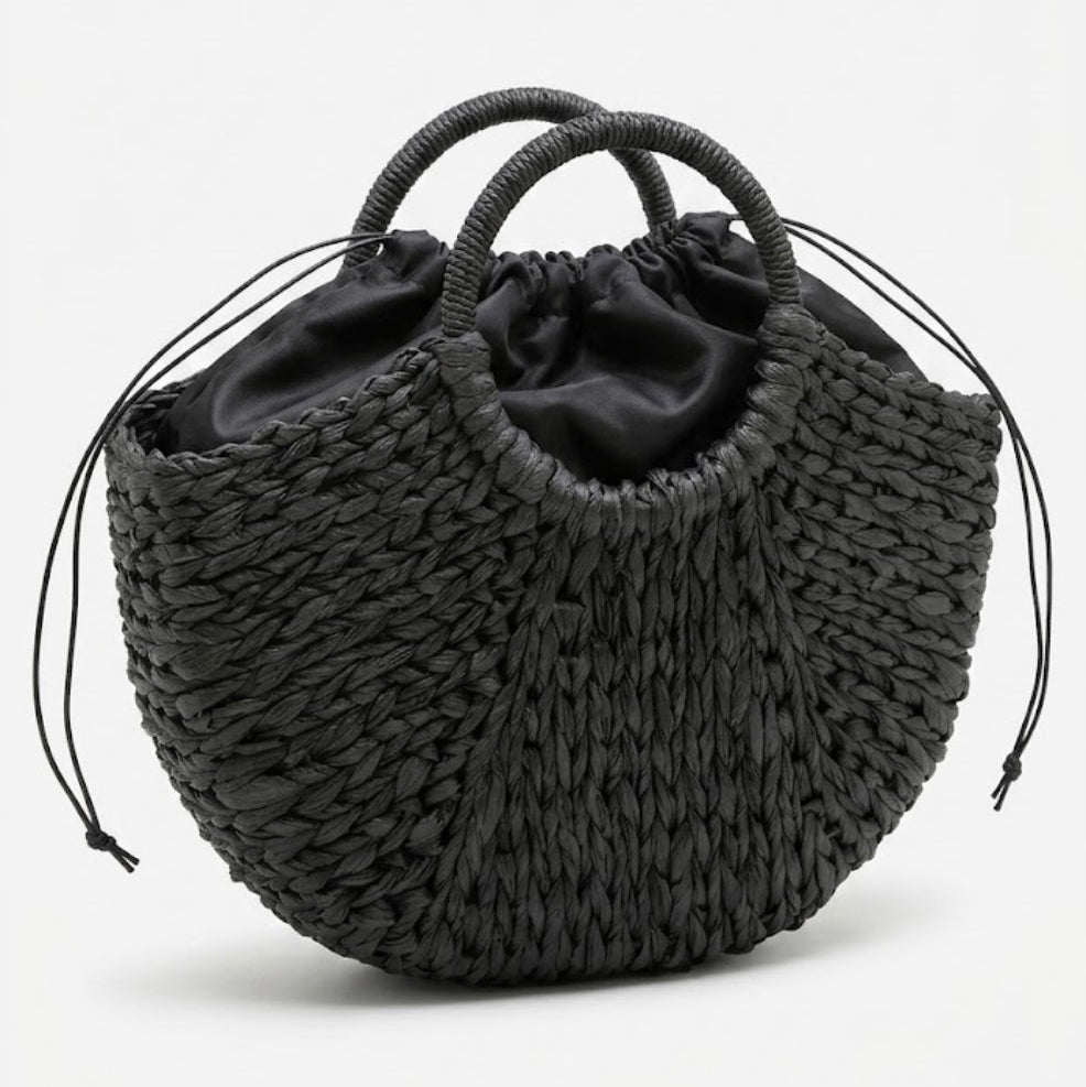 black crescent straw bag side angle with drawstring closure