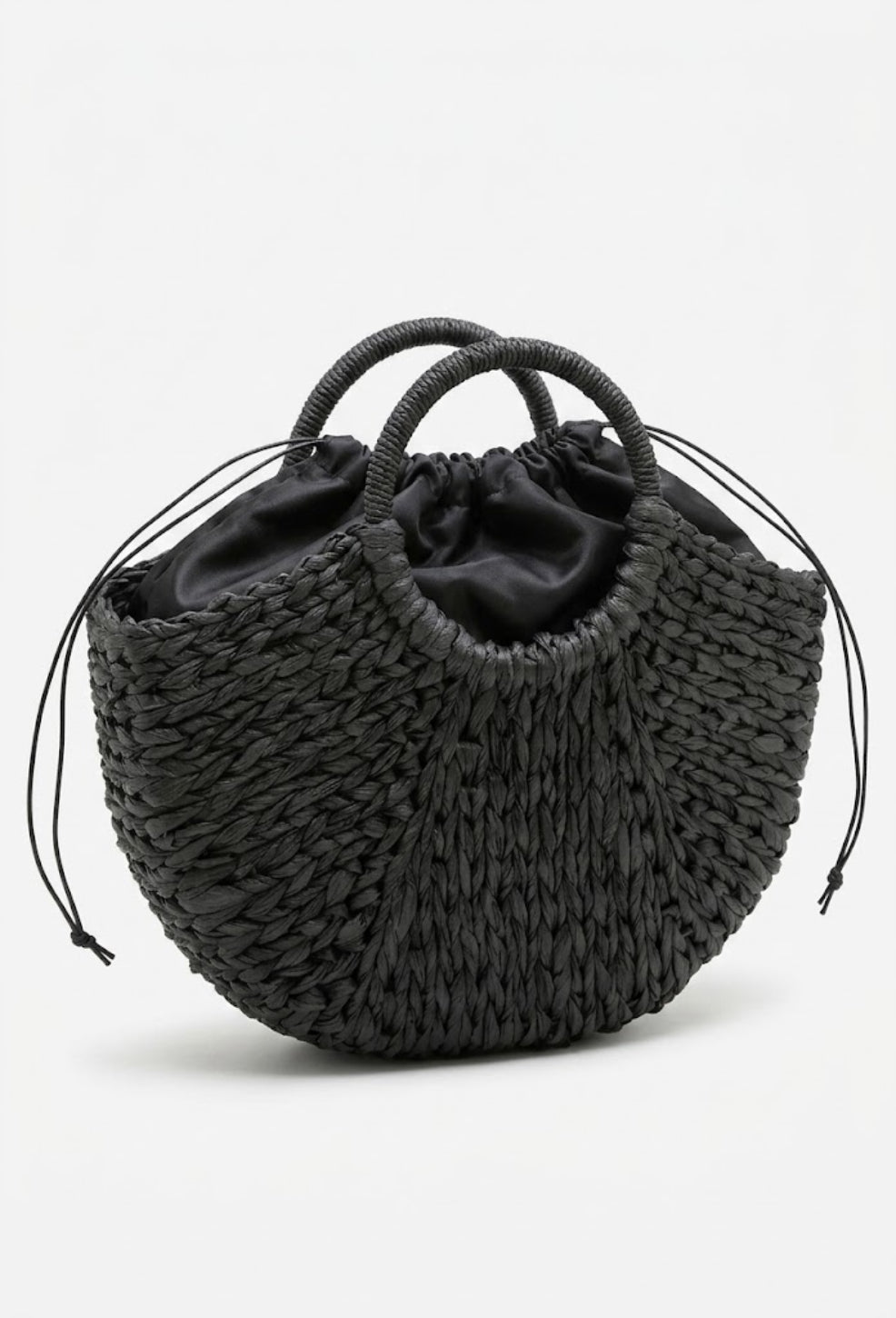 black crescent straw bag side angle with drawstring closure