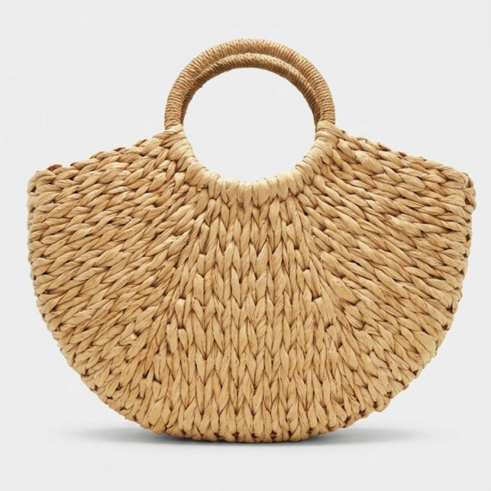 natural tan crescent straw bag front view with round handles