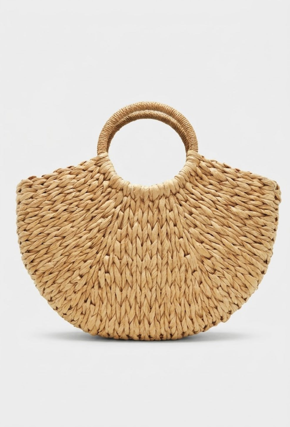 natural tan crescent straw bag front view with round handles