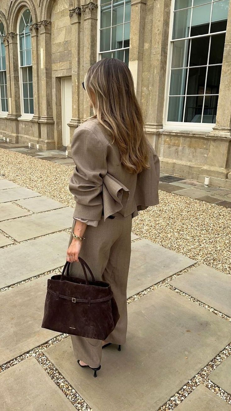 1. Sienna belted suede top handle bag in deep brown styled with a neutral women’s suit