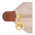 Le Pliage Medium Tote Bag in Paper close-up showing gold-tone zipper and brown trim
