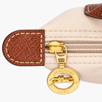 Le Pliage Mini Pouch in Black, three-quarter view with brown trim