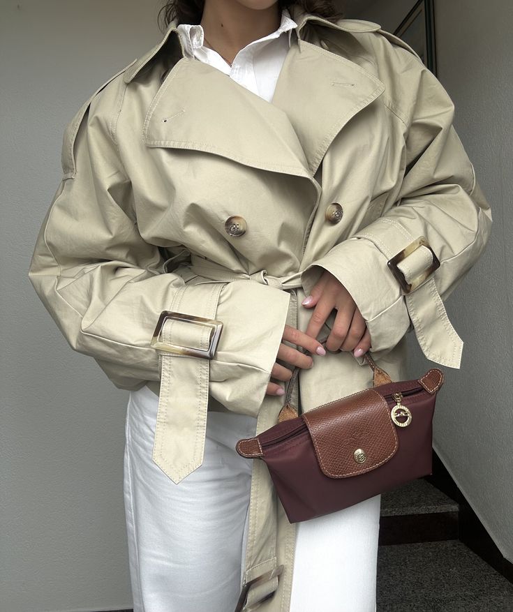 Le Pliage Mini Pouch in Burgundy worn with a belted trench coat