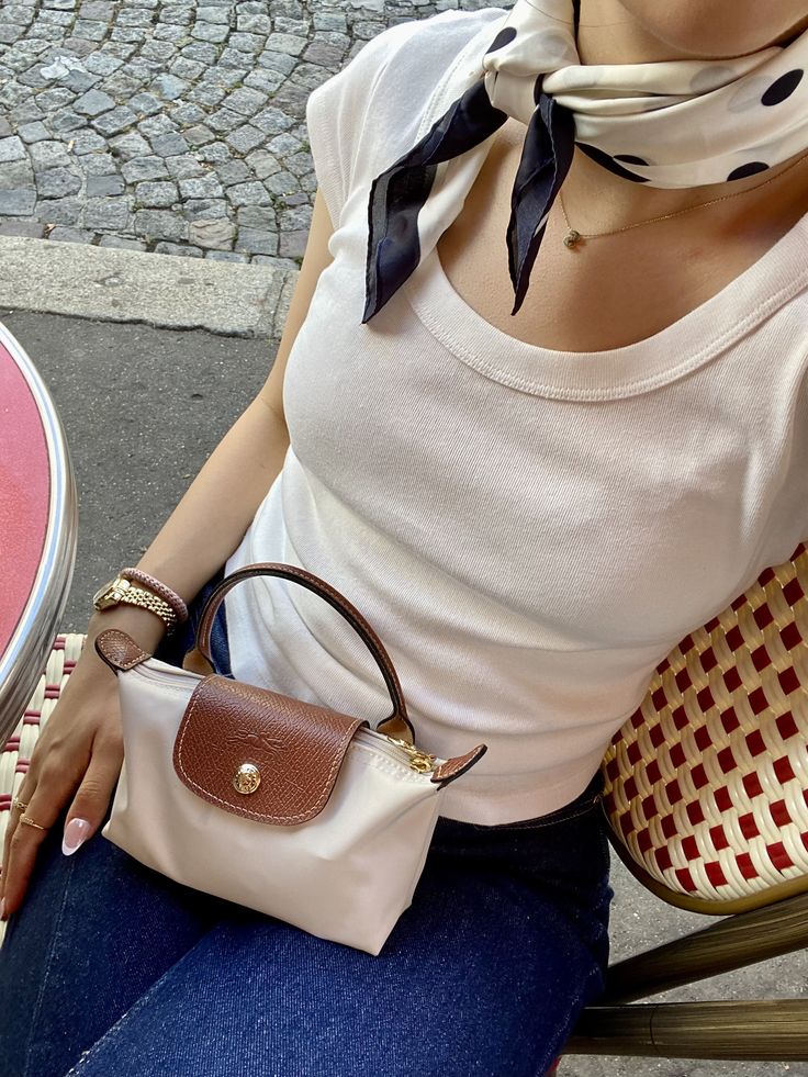 Le Pliage Mini Pouch in Paper beige styled at an outdoor café