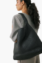woman wearing oversized black woven shoulder tote bag - black - tote bag