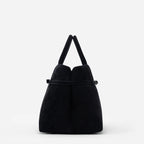 Sienna black suede top handle bag side view with belted detail and structured silhouette