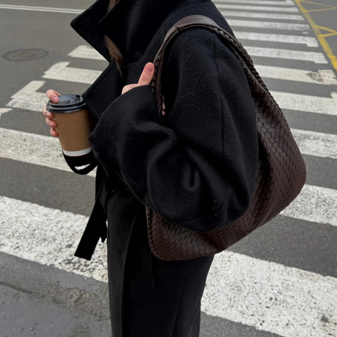 woman carrying dark brown woven hobo shoulder bag street style