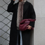 women wearing black woven hobo shoulder bag long coat street style