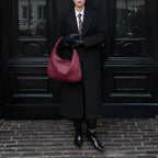 women carrying woven hobo shoulder bag black coat street style
