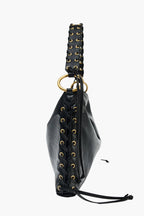 braided handle gold ring hardware close up black corset bag women