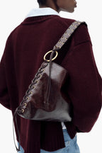 women wearing brown corset shoulder bag under arm street style